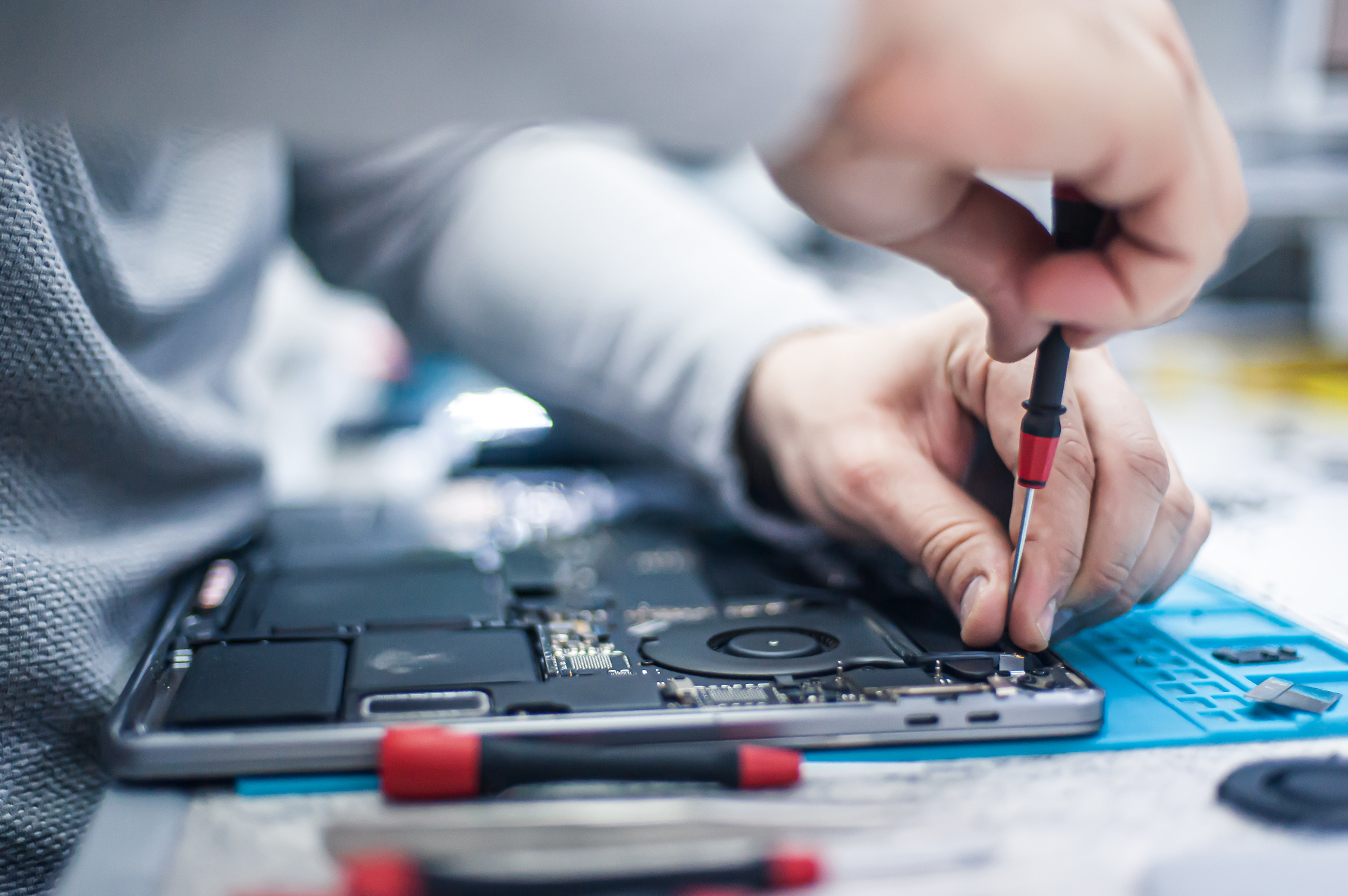Technician repairing a laptop computer